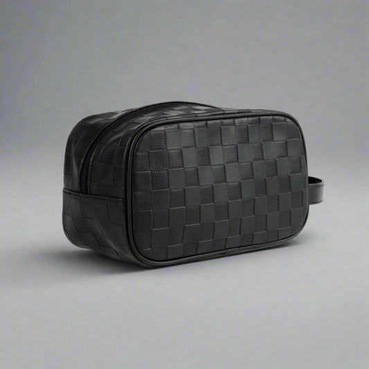 Black woven leather toiletry bag on a white background
